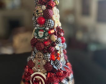 Fancy buffalo plaid holiday 11" table top tree. Red and black fabric plus sparkly whimsey set on a rustic pine stand.