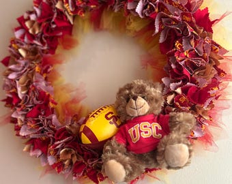 USC spirit 14" wreath perfect for your favorite Trojan. Cardinal, and gold and featuring a stuffy bear and football. Hand-curated rare item.