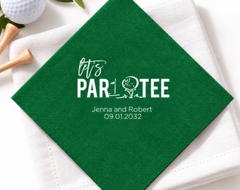 May include: A square dark green paper napkin featuring white printed text that reads Let's PAR-TEE with a golf ball and flag graphic, followed by the names Jenna and Robert and the date 09.01.2032 in a clean, sans-serif font.