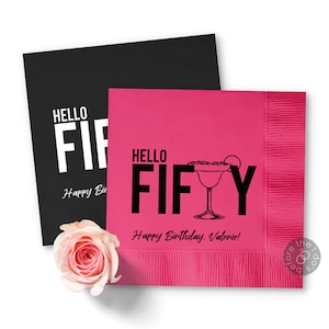 May include: Pink paper napkins with black text that reads "Hello Fifty" and "Happy Birthday, Valerie!" with a black and white illustration of a margarita glass.