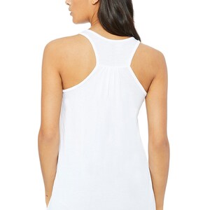 May include: White racerback tank top with a gathered detail in the back.