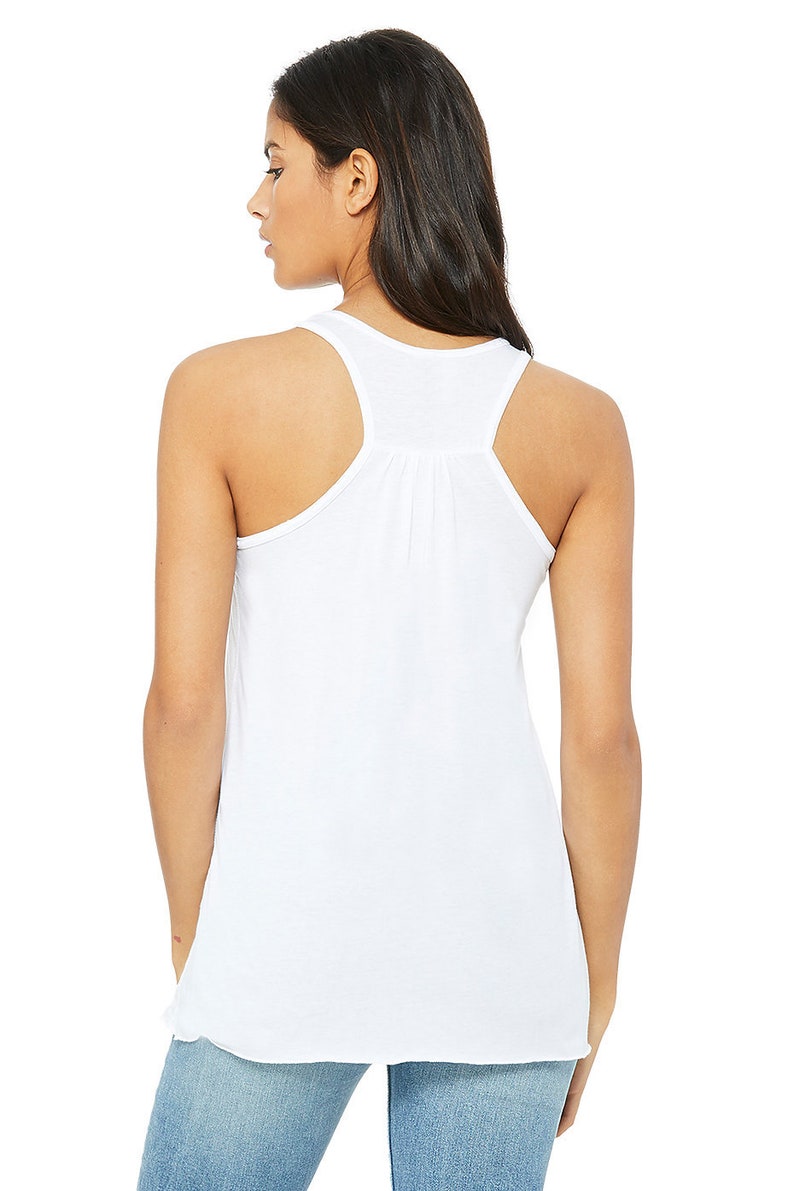 May include: White racerback tank top with a gathered detail in the back.