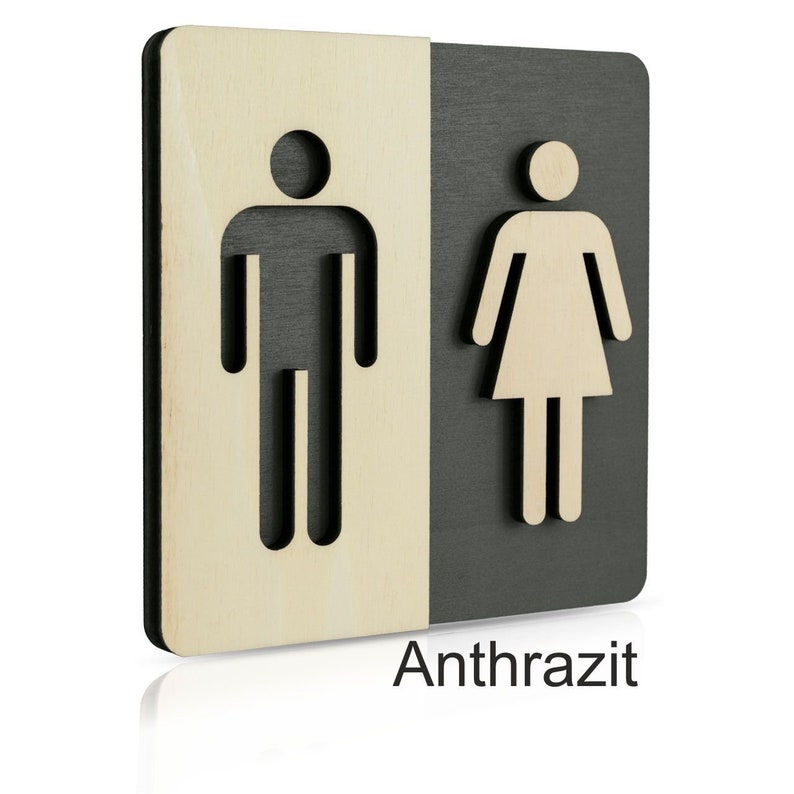 Puede incluir: Un letrero de madera con acabado negro y madera natural. El letrero tiene un s&iacute;mbolo masculino y femenino cortado en la madera. El texto "Anthrazit" est&aacute; impreso debajo de los s&iacute;mbolos.