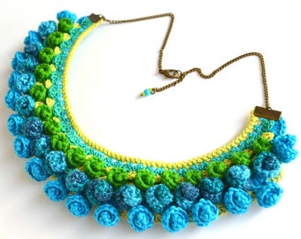 chunky modern crochet necklace at the base of the neck in vibrant turquoise hues, statement mexican inspired artistic crochet jewelry