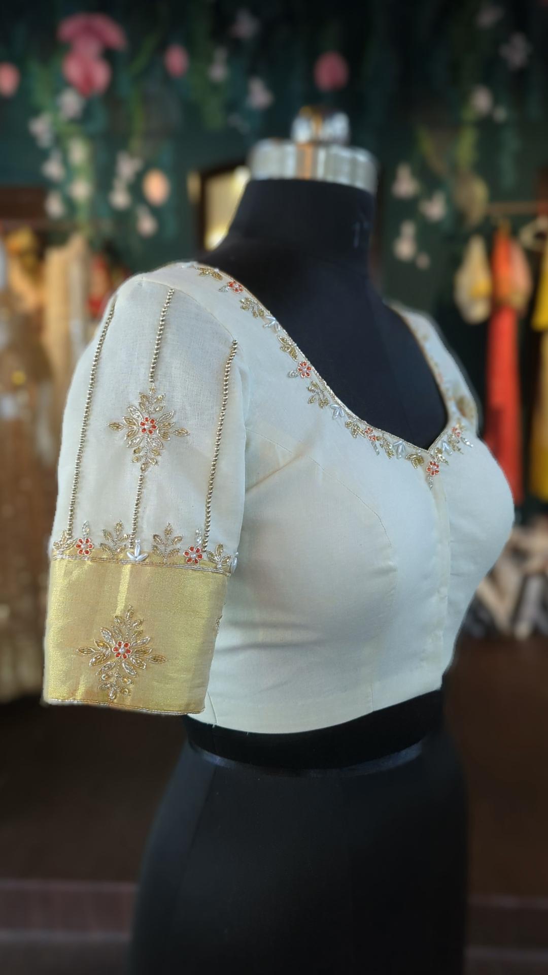 white blouse with gold accents