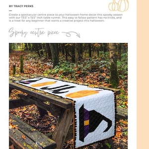 May include: A Halloween table runner with a witch hat and pumpkin design. The white runner, measuring 73.5" x 13.5", is displayed on a wooden picnic table in an outdoor setting. The text "THE HALLOWEEN TABLE RUNNER PATTERN" is at the top.
