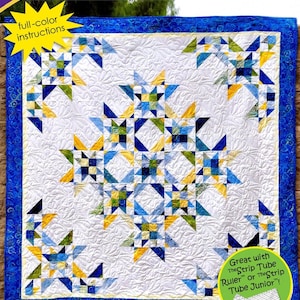 May include: A quilt pattern titled Nine Sisters by Cozy Quilt Designs featuring a white background with blue, green, and yellow star motifs. The pattern includes full-color instructions for 2 1/2 inch strips and is compatible with The Strip Tube Ruler.