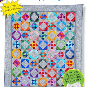 May include: A quilt pattern titled "Hash Browns" with a colorful patchwork design. The quilt features squares of various colors, including orange, blue, and purple, set against a gray background. The pattern is designed by Daniela Stout and includes full-color instructions.