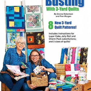 May include: The cover of a quilting book titled "Stash Busting With 3-Yard Quilts" featuring two women surrounded by colorful fabrics and quilts. The book cover includes the text "8 New 3-Yard Quilt Patterns!" and "Includes instructions for Layer Cake, Jelly Roll and Charm Pack substitutions; and 3 sizes of quilts!"