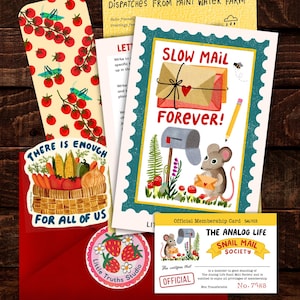 May include: A collection of stationery items including a bookmark with tomatoes and grasshoppers, a card with a mouse and the text SLOW MAIL FOREVER, a sticker with a vegetable basket and the text THERE IS ENOUGH FOR ALL OF US, and a membership card.
