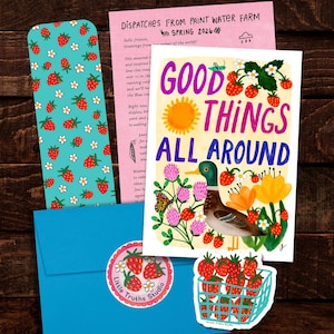 May include: A stationery set featuring a bookmark with a strawberry pattern, a pink newsletter titled Dispatches From Paint Water Farm, a blue envelope with a strawberry sticker, and a card with a mallard duck and the text Good Things All Around.