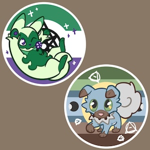 May include: Two circular stickers featuring cartoon animals. The top sticker shows a green and white creature with a purple eye and a lollipop against a green, white, and purple striped background. The bottom sticker shows a blue and brown puppy-like creature against a green, blue, and brown striped background with white circular symbols.