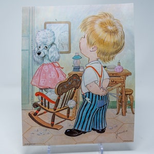 May include: A cartoon illustration of a young boy with blonde hair and blue and white striped pants standing next to a white poodle wearing a pink dress and sitting in a rocking chair. The poodle is getting a haircut. The boy is holding a pair of scissors and a comb.