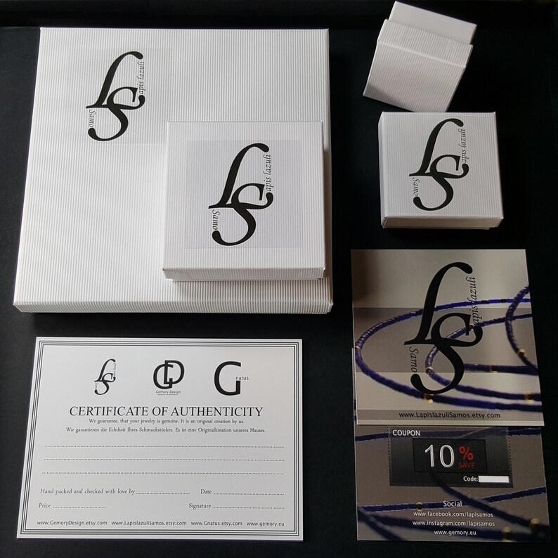 May include: A white box with a black logo that says "Gemory Design" and "Samo" on it. The box is sitting on a white surface. There is a certificate of authenticity with the same logo and the text "Certificate of Authenticity" on it. There is also a coupon with the text "10% Save" on it.