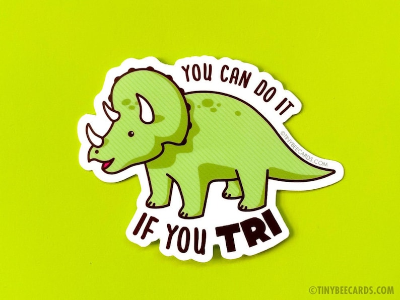May include: A green cartoon triceratops dinosaur with the text "You can do it if you tri" in a white circle around it.