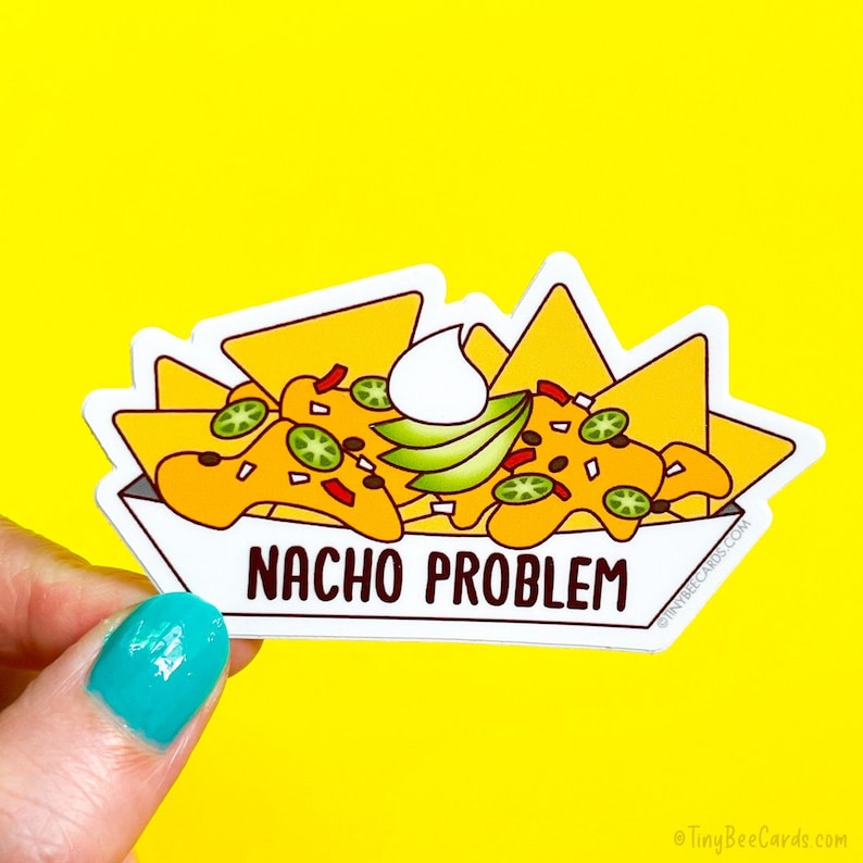 May include: A white sticker with a cartoon illustration of nachos with sour cream, guacamole, and jalapenos. The text "NACHO PROBLEM" is printed below the nachos.