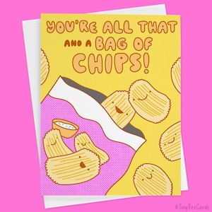 May include: A yellow card with the text "You're all that and a bag of chips!" in black and orange. The card features a cartoon illustration of a bag of chips with smiling potato chips inside.