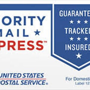 May include: A white and blue Priority Mail Express label from the United States Postal Service. The label includes the text "Guaranteed, Tracked, Insured" and "For Domestic Use Only".