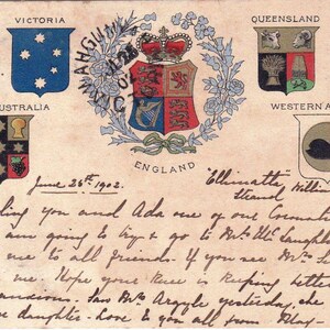 May include: Vintage postcard featuring coats of arms for Australian states and England. The postcard includes handwritten text and the date June 26th, 1902. The design includes floral embellishments and a central emblem.