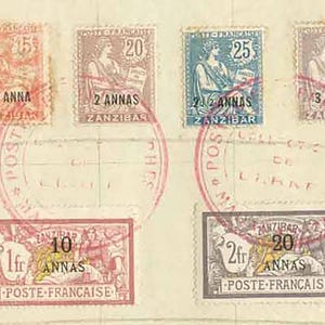 May include: A collection of vintage postage stamps in various colors, including green, red, orange, purple, and blue. The stamps feature different denominations and imagery, with red circular postmarks. The stamps are arranged on a cream-colored background.