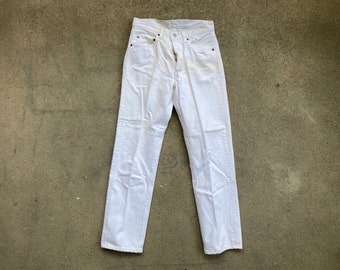 May include: White denim jeans with a straight leg and a classic five-pocket design.