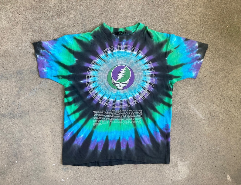 CAMISETA ANTI-TEÑO DE LA GIRA DEL 25.º ANIVERSARIO DE GRATEFUL DEAD, de la década de 1990, talla mediana, azul líquido, estampado de calaveras Dead And Gone por todas partes, 1990 imagen 1