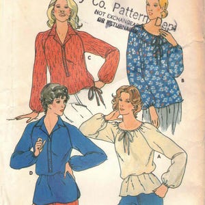 May include: Vintage Butterick sewing pattern 6333, featuring illustrations of four different blouses. The pattern includes a red blouse, a blue floral blouse, a blue blouse, and a cream-colored blouse. The pattern is labeled "Young Stuff".