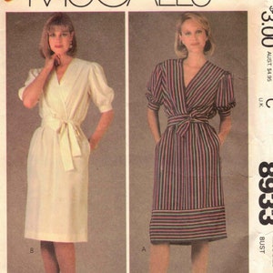 May include: A sewing pattern for a dress with a wrap style bodice and a skirt that hits above the knee. The pattern is for size 10, bust 32 1/2 inches. The pattern is from McCall's and is called Easy McCall's 8933.