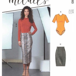 May include: A sewing pattern for a bodysuit and skirt. The pattern includes multiple views and simple instructions. The hashtag #FoxieMcCalls is included. The pattern is designed and printed in the USA.