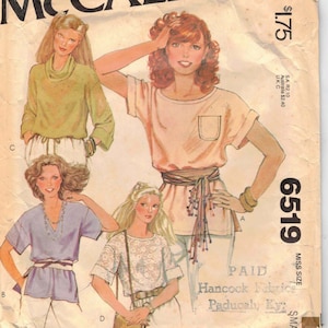 May include: A sewing pattern for a women's blouse with a tie belt. The pattern is from McCall's and is called "Carefree" patterns. The pattern number is 6519 and the size is "Miss Size Small".