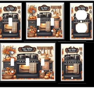 May include: Decorative light switch covers featuring a cozy kitchen theme. Each cover showcases a black stove with a pie in the oven, pumpkins, and the text "Cozy Kitchen Happy Heart". The covers are framed with a white border.