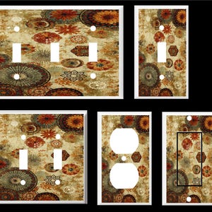 May include: Set of decorative light switch and outlet covers featuring a colorful, abstract pattern with circles, swirls, and floral motifs in shades of brown, orange, and green.