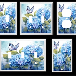 May include: Set of five light switch and outlet covers featuring a watercolor painting of blue hydrangeas and butterflies. The covers are white with a glossy finish.