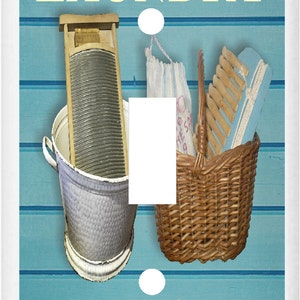 May include: A light blue and white light switch cover with the words "Laundry Loads of Fun" and images of a washboard, a basket, and a clothes peg.