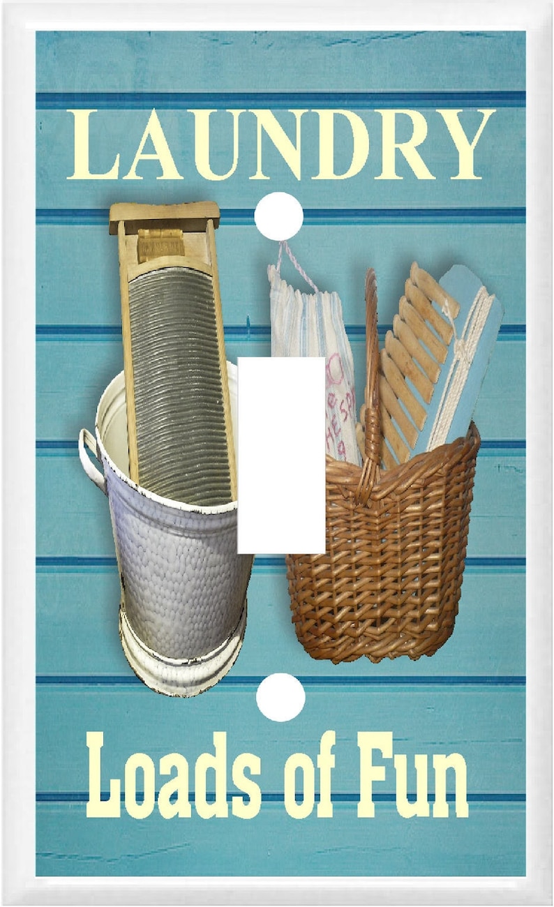 May include: A light blue and white light switch cover with the words "Laundry Loads of Fun" and images of a washboard, a basket, and a clothes peg.