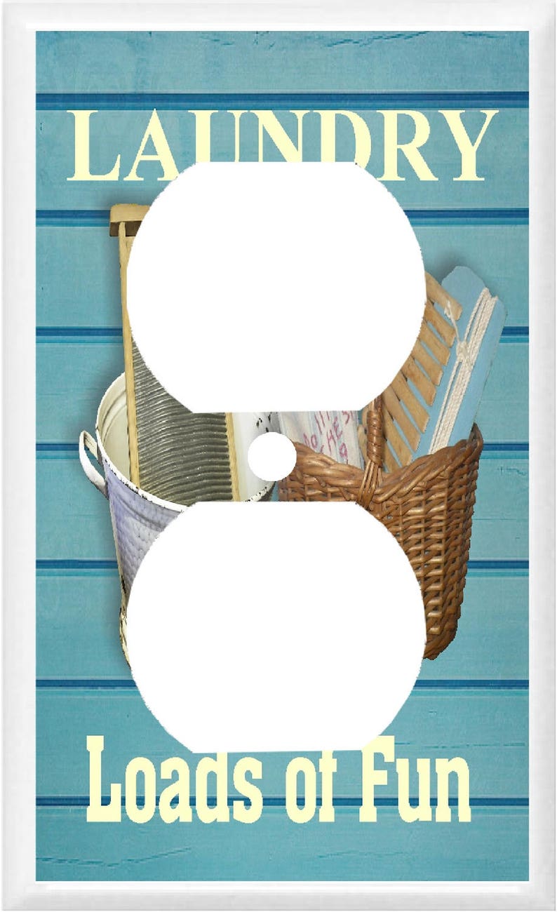 May include: A light blue and white wall outlet cover with a vintage laundry theme. The cover features a white washboard, a wicker basket, and a wooden clothes brush. The text "Laundry Loads of Fun" is printed in yellow on the cover.