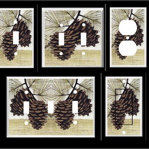 May include: A collection of decorative light switch and outlet covers featuring a nature-inspired design. Each cover showcases a detailed illustration of pine cones and pine needles in shades of brown, green, and beige, set against a neutral background.