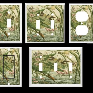 May include: A set of four light switch covers featuring a vintage illustration of dragonflies and water lilies in shades of green, brown, and white.