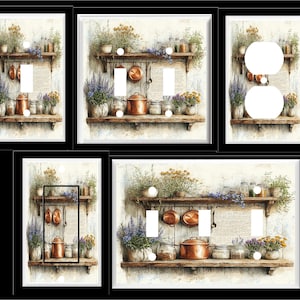 May include: Decorative light switch covers featuring a watercolor design of a rustic kitchen scene. The artwork includes wooden shelves, copper pots, jars, and floral arrangements. The covers are available in various configurations, including single and double switch and outlet covers.