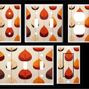 May include: Set of six light switch and outlet covers featuring a repeating pattern of stylized orange, red, and brown leaves on a cream background.