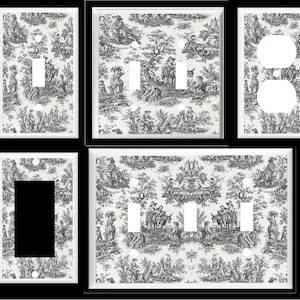 May include: Set of four black and white patterned light switch and outlet covers. The pattern features a toile design with a repeating pattern of figures and trees.