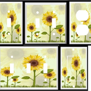 May include: Set of six light switch and outlet covers featuring a sunflower design. The covers are white with a yellow background and feature sunflowers with green leaves. The sunflowers are in various stages of bloom, with some fully open and others still in bud. The background is a light yellow with a subtle pattern of smaller sunflowers.