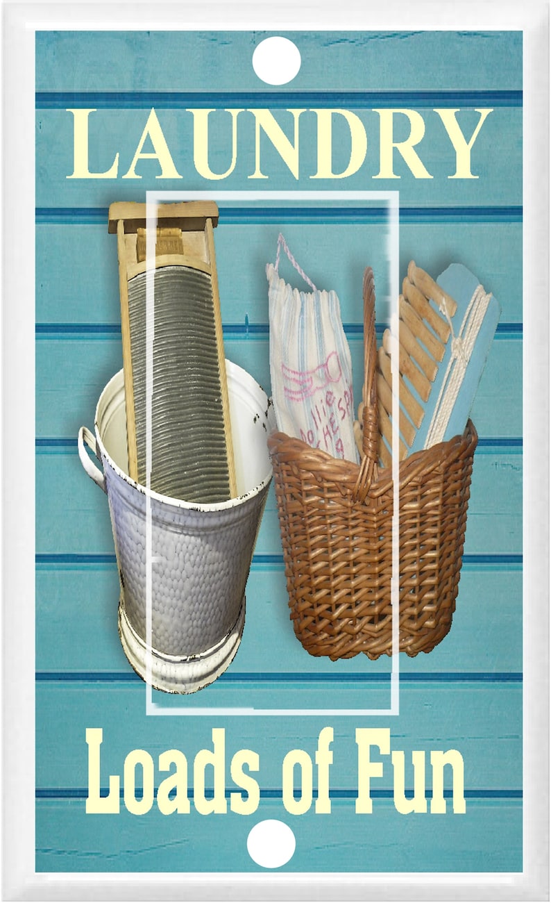May include: A white light switch cover with a blue and white woodgrain background. The switch cover has the words "Laundry" and "Loads of Fun" in yellow text. The image also shows a vintage washboard, a basket, and a laundry brush.