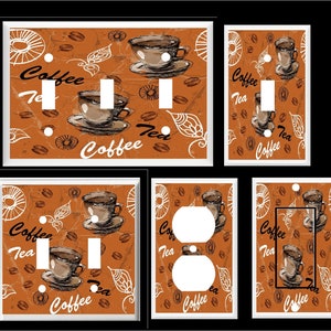 May include: Set of four light switch and outlet covers featuring a brown and white coffee and tea themed design. The design includes coffee cups, coffee beans, and the words "Coffee" and "Tea".