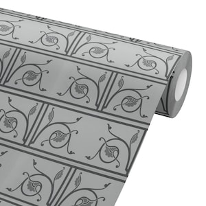 May include: A roll of gray wallpaper with a repeating pattern of stylized floral and leaf motifs in dark gray. The design is framed by dark gray borders, creating a classic, elegant look. The wallpaper is on a white background.