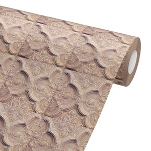 May include: A roll of decorative wallpaper featuring a repeating pattern of ornate, embossed tiles. The tiles have a warm, neutral color with detailed floral and scrollwork designs, creating a vintage or antique aesthetic. The roll is partially unrolled, revealing the pattern.