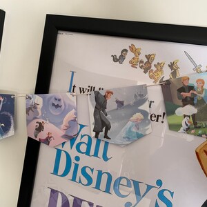 May include: A Frozen themed banner with images of Elsa, Olaf, Anna, and Kristoff. The banner is strung with white twine and has a blue and white color scheme. The banner says "It will..." and "Walt Disney's Frozen".