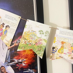 May include: A decorative bunting banner made from pages of a children's book featuring illustrations of a teacher and students on a field trip. The pages are strung together with brown twine and display colorful drawings and printed text.