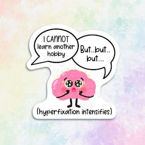 Peut inclure: Un personnage de dessin animé en forme de cerveau rose avec de grands yeux et une bulle de dialogue qui dit "Je ne peux pas apprendre un autre passe-temps. Mais...mais...mais..." et une légende en dessous qui dit "(hyperfixation s'intensifie)"