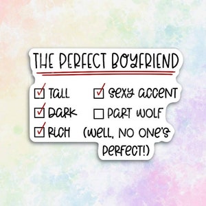 May include: A white sticker with a checklist titled "The Perfect Boyfriend" with the following items checked off: Tall, Dark, Rich. The checklist also includes the following unchecked item: Part Wolf. The sticker also includes the text: "(Well, no one's perfect!)"